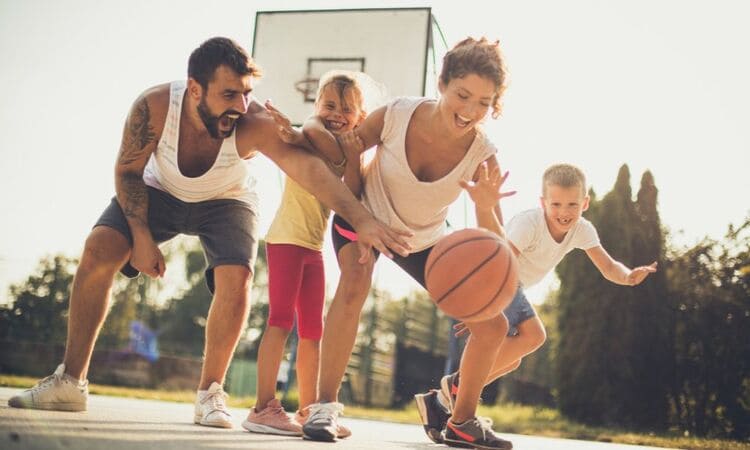 Sport et équilibre de vie : famille jouant au basket ensemble dans la joie